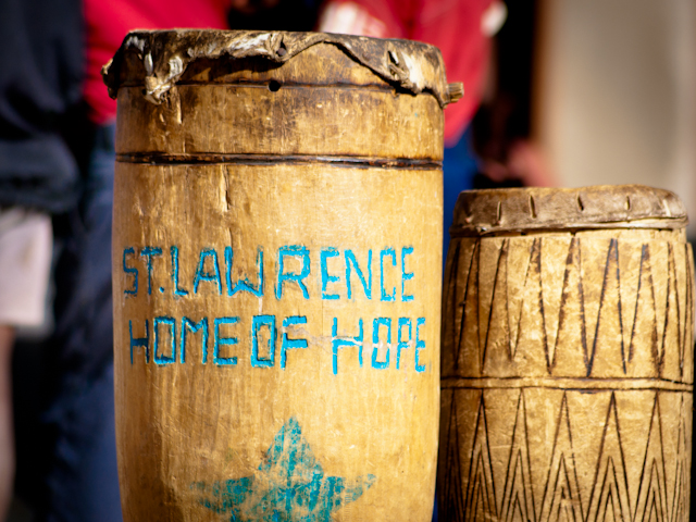 Traditional wooden drums bearing the St. Lawrence Home of Hope name